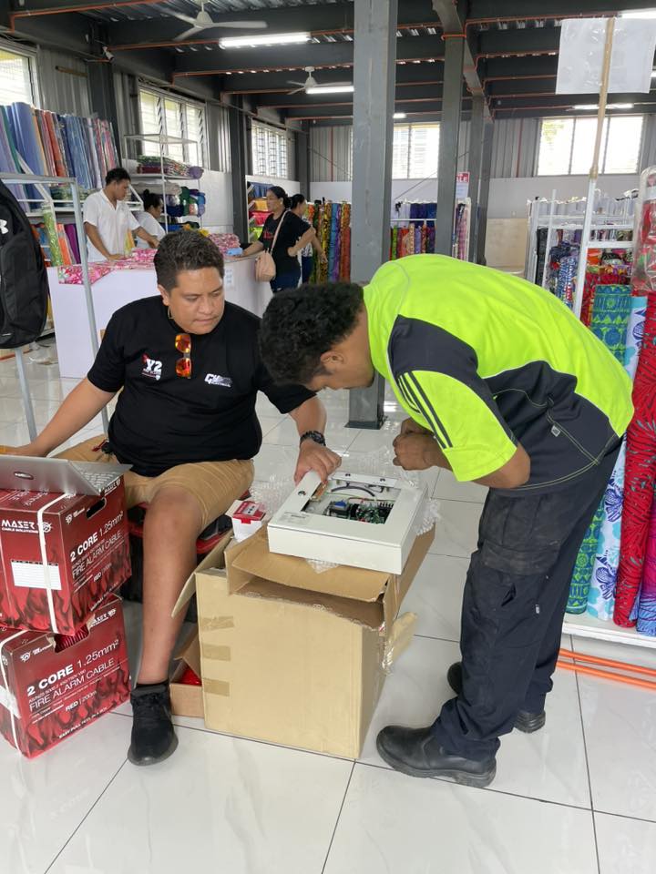 Fire alarm service crew at work